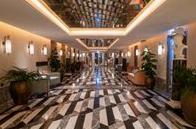 Warmly lit elegant hotel lobby with marble floors